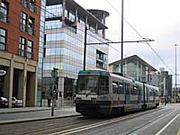 Metrolink tram 1020 heads down Lower Mosley Street in Manchester city centre on its way to Altrincham. In 2012 trams from Rochdale and in 2011 Oldham will follow this route as far as Trafford Bar and then run to Chorlton.  Tony Young.